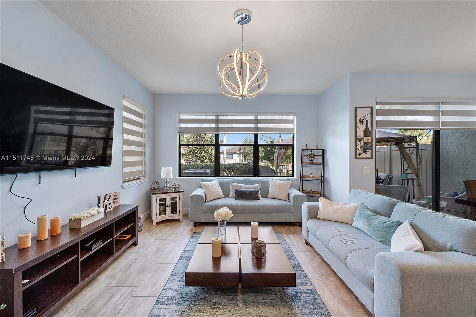 8339 Cadre Noir Road Lake Worth, FL 33467 - Photo 5 of 44 a living room with furniture fireplace and flat screen tv