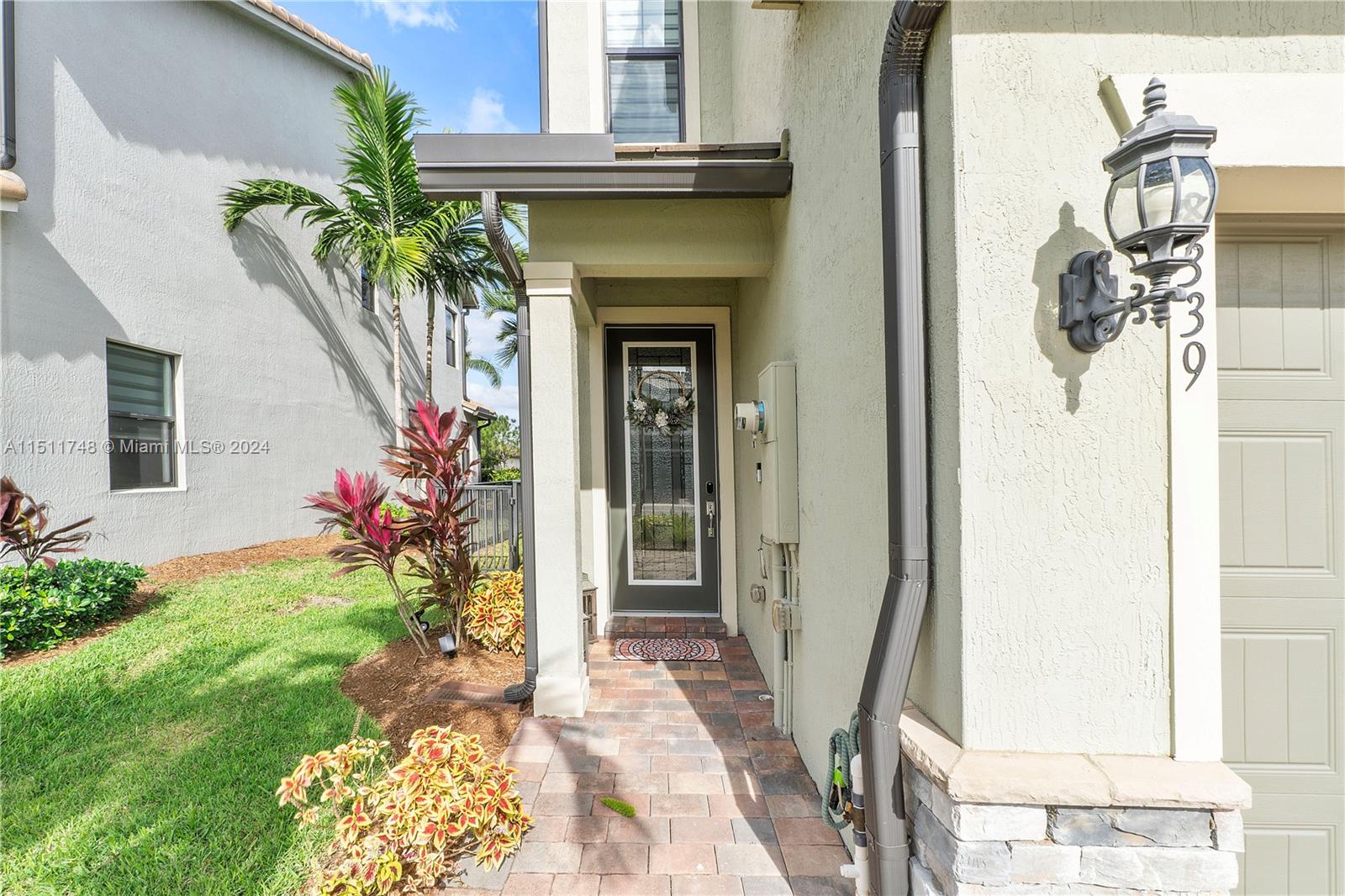 8339 Cadre Noir Road Lake Worth, FL 33467 - Photo 10 of 44 a front view of a house with a porch