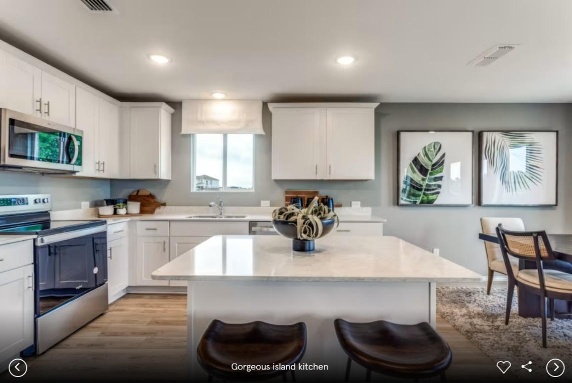 120 Golden Bell Way Buda, TX 78610 - Photo 4 of 10 a kitchen with a sink cabinets and window