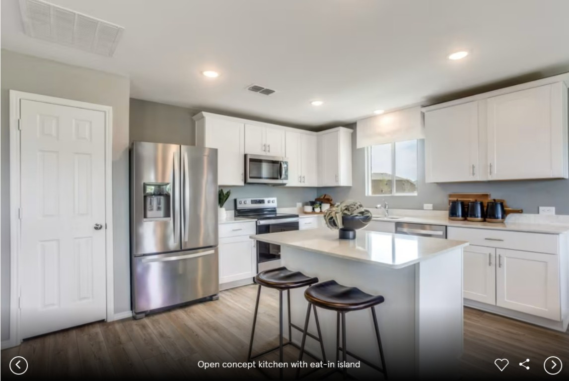 120 Golden Bell Way Buda, TX 78610 - Photo 5 of 10 a kitchen with stainless steel appliances granite countertop a refrigerator sink and cabinets