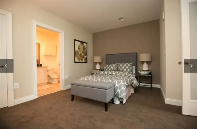 a bed sitting in a bedroom next to a window