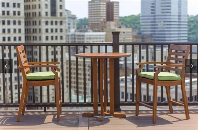 a porch with a bench next to yard