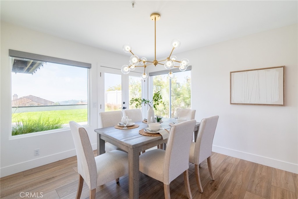 27 Burriana San Clemente, CA 92672 - Photo 14 of 66 a view of a dining room with furniture a chandelier and wooden floor