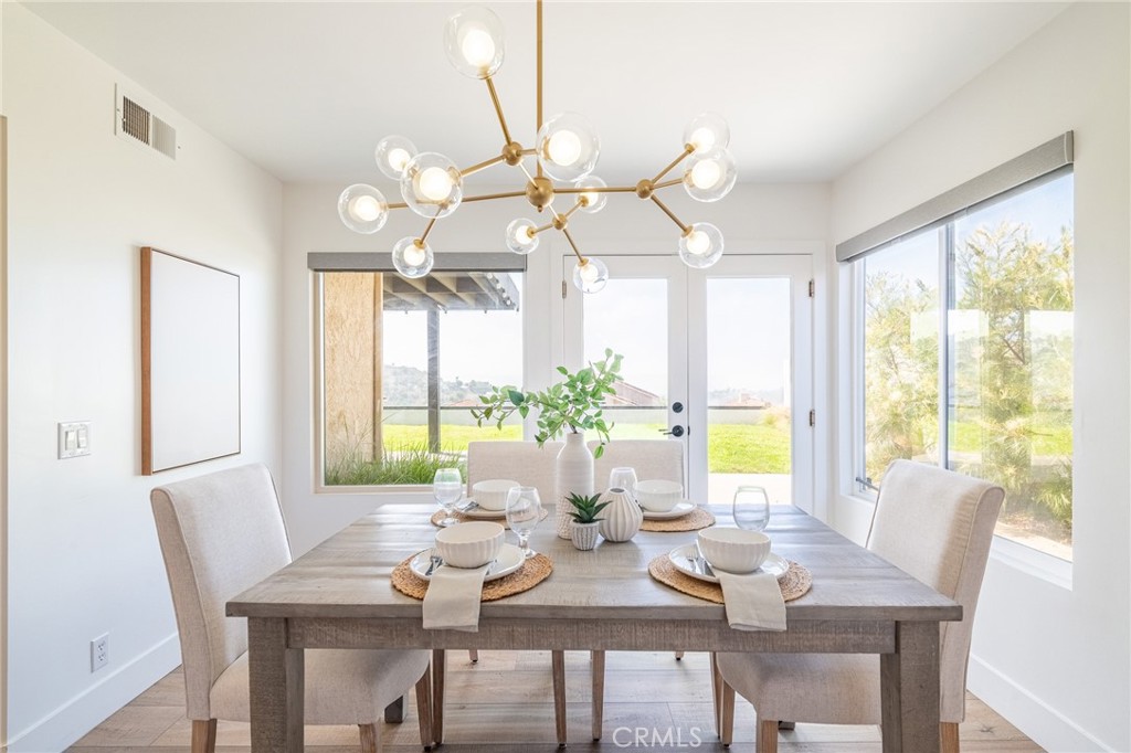 27 Burriana San Clemente, CA 92672 - Photo 16 of 66 a view of a dining room with furniture large windows and wooden floor