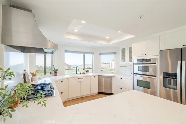 a view of a kitchen with refrigerator and a fireplace
