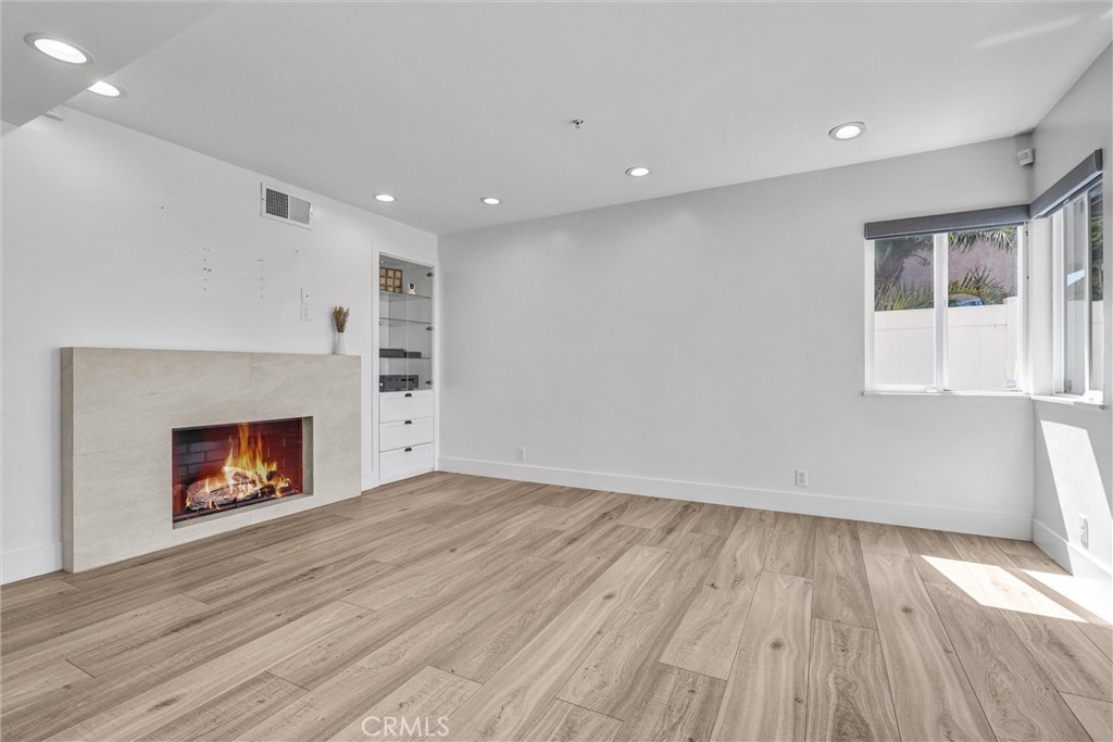 27 Burriana San Clemente, CA 92672 - Photo 24 of 66 an empty room with wooden floor fireplace and windows