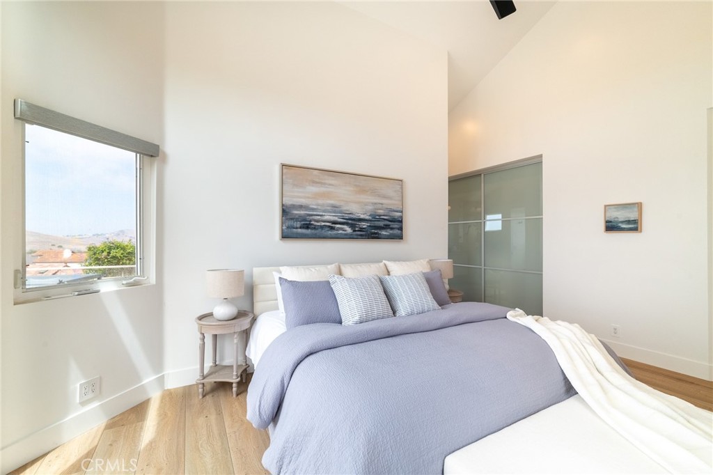 27 Burriana San Clemente, CA 92672 - Photo 32 of 66 a bedroom with a bed and a painting on the wall