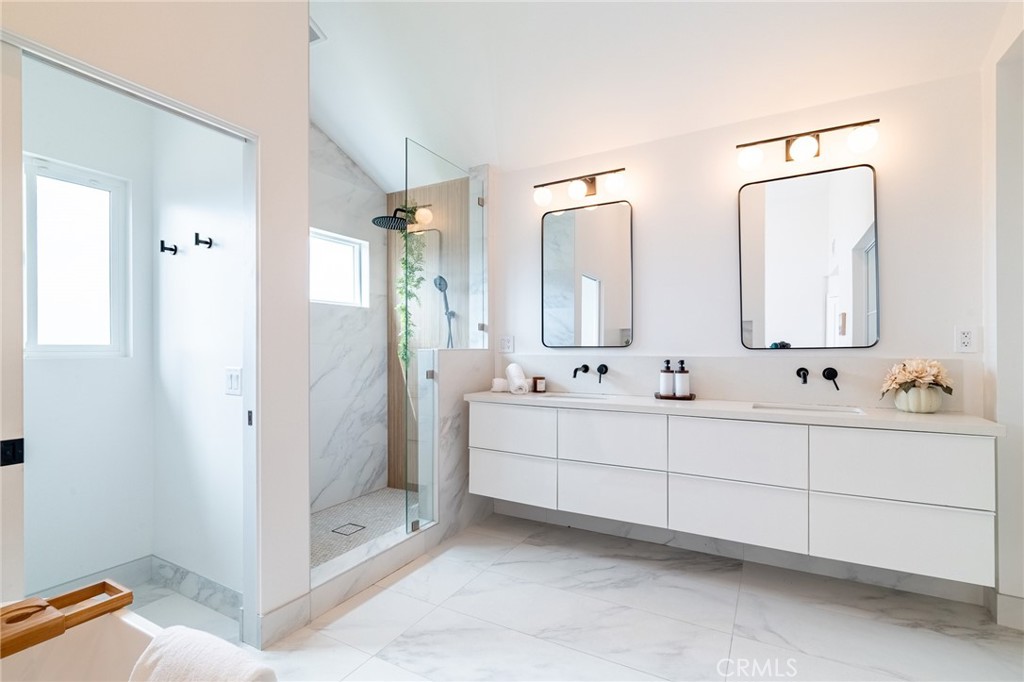 27 Burriana San Clemente, CA 92672 - Photo 39 of 66 a bathroom with double vanity sinks a toilet a mirror and shower