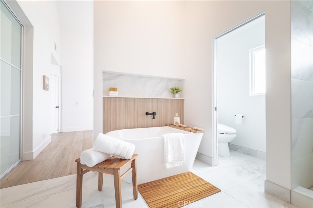 27 Burriana San Clemente, CA 92672 - Photo 43 of 66 a spacious bedroom with a bed and a table