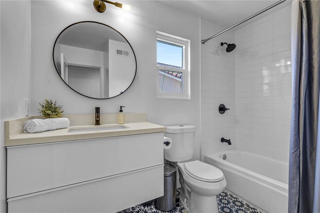 27 Burriana San Clemente, CA 92672 - Photo 48 of 66 a bathroom with a toilet sink and mirror