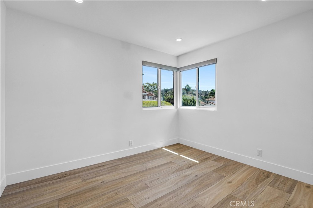 27 Burriana San Clemente, CA 92672 - Photo 49 of 66 a view of an empty room with wooden floor and a window