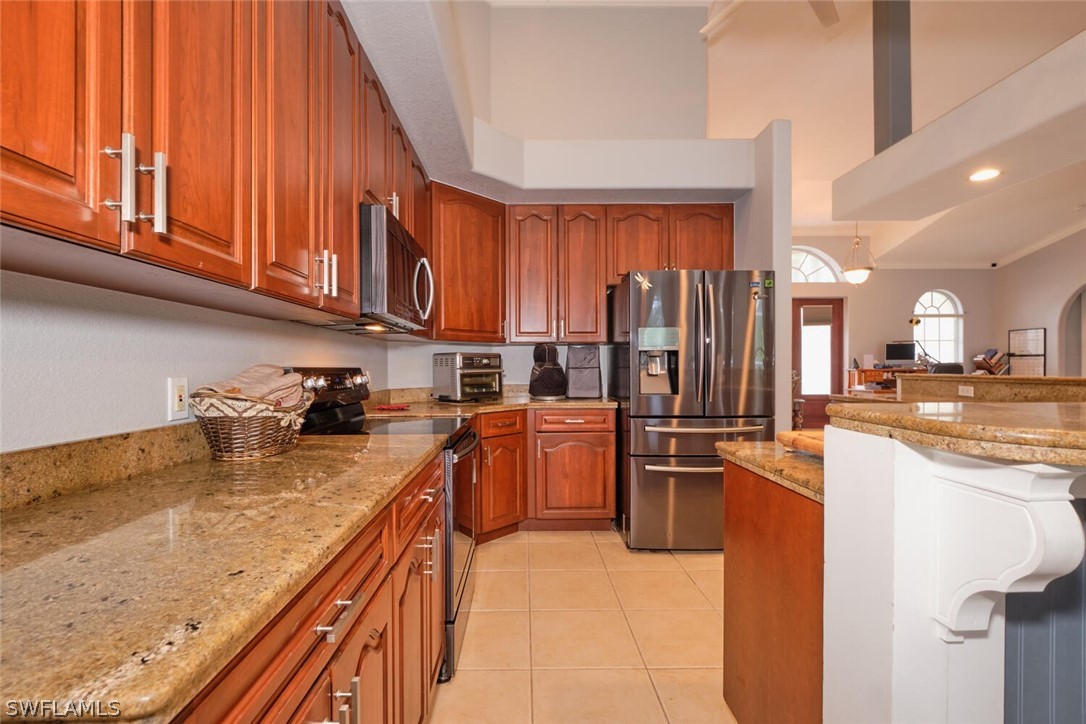 2050 Balsey Road Alva, FL 33920 - Photo 12 of 35 a kitchen with refrigerator and cabinets