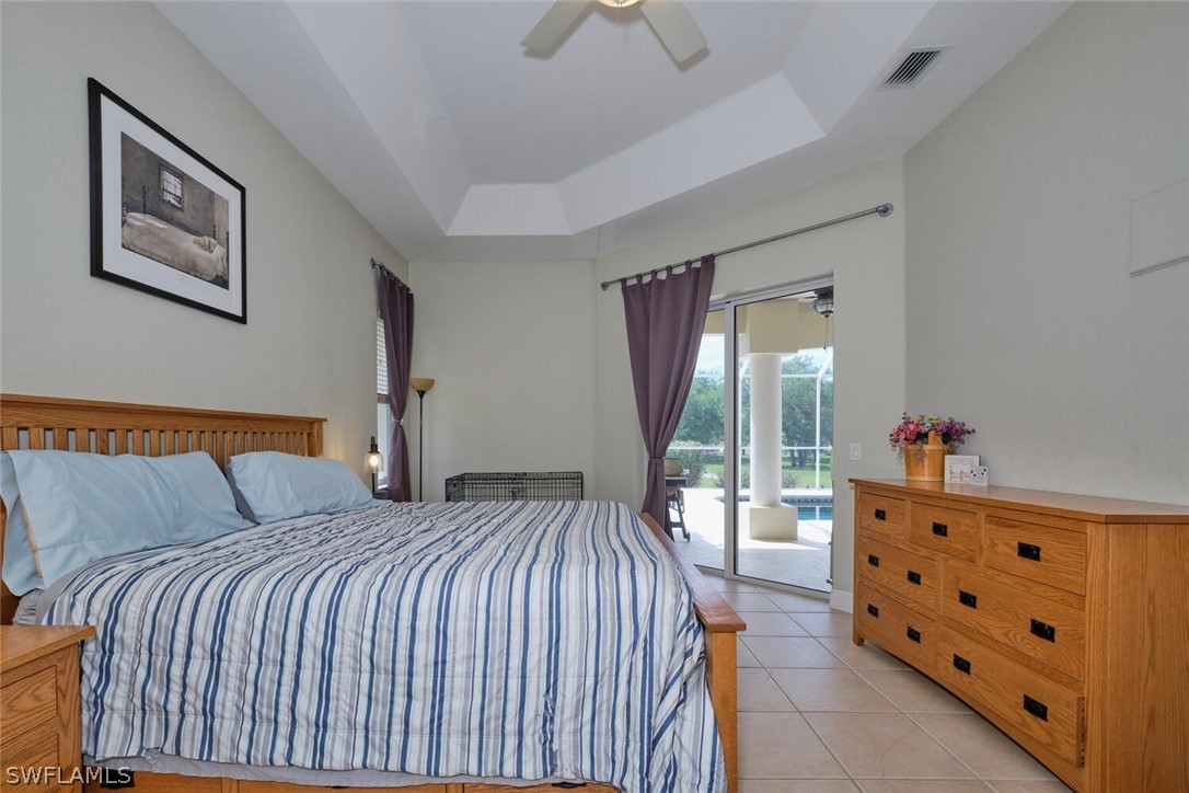 2050 Balsey Road Alva, FL 33920 - Photo 15 of 35 a bedroom with a bed a dresser next to a window