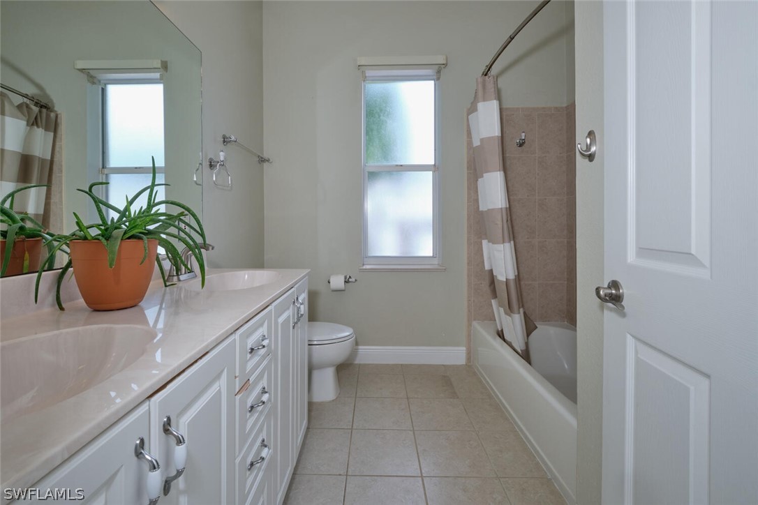 2050 Balsey Road Alva, FL 33920 - Photo 20 of 35 a bathroom with a granite countertop sink a toilet and shower