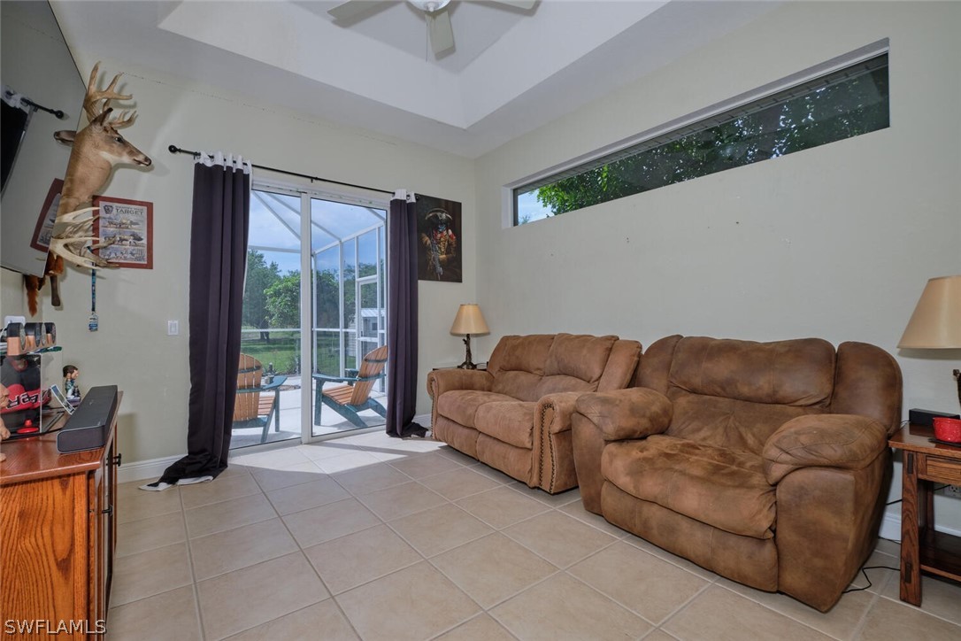 2050 Balsey Road Alva, FL 33920 - Photo 21 of 35 a living room with furniture and a floor to ceiling window
