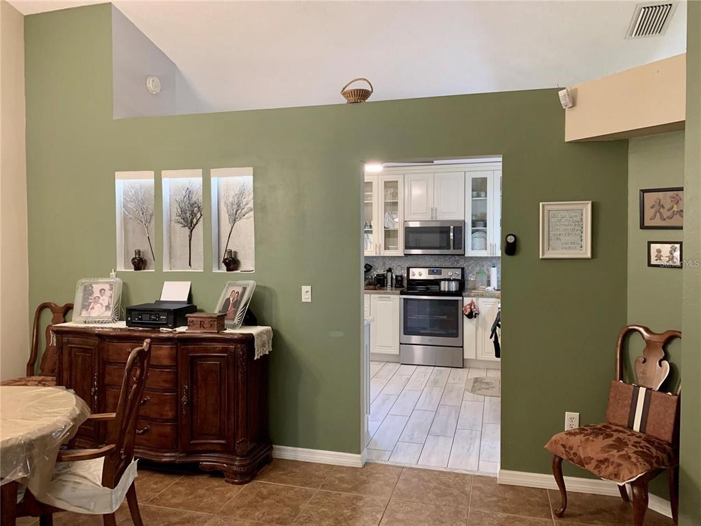 8553 Manassas Road Tampa, FL 33635 - Photo 14 of 33 a kitchen with cabinets and chairs