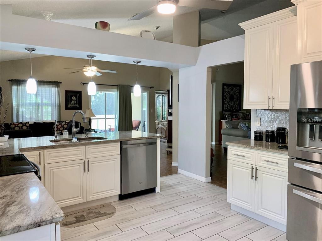 8553 Manassas Road Tampa, FL 33635 - Photo 16 of 33 a kitchen with white cabinets and white appliances