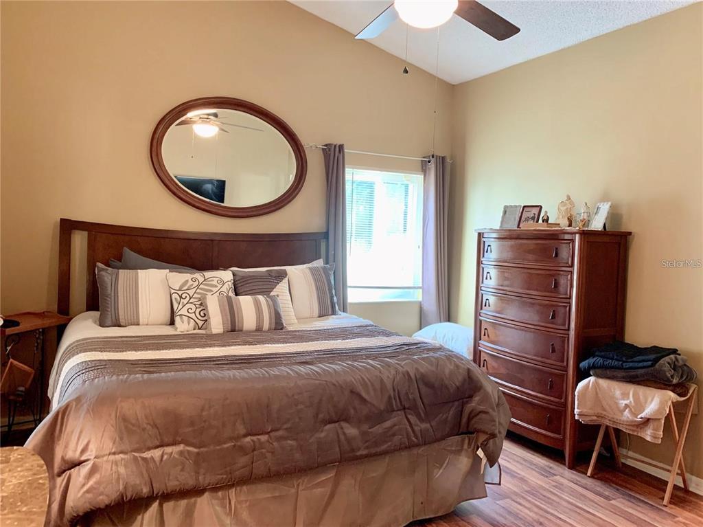 8553 Manassas Road Tampa, FL 33635 - Photo 20 of 33 a bedroom with a bed and a chair