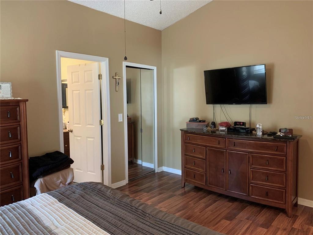 8553 Manassas Road Tampa, FL 33635 - Photo 23 of 33 a room with a bed and a flat screen tv