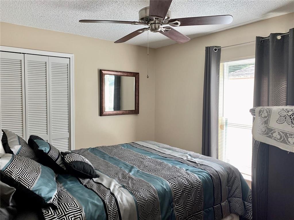 8553 Manassas Road Tampa, FL 33635 - Photo 24 of 33 a bedroom with a bed and a chandelier