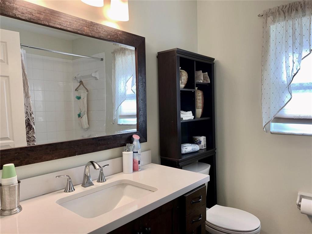 8553 Manassas Road Tampa, FL 33635 - Photo 25 of 33 a bathroom with a toilet sink and mirror