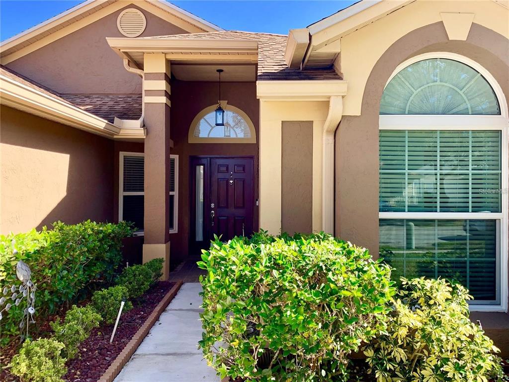 8553 Manassas Road Tampa, FL 33635 - Photo 4 of 33 a front view of a house with garden