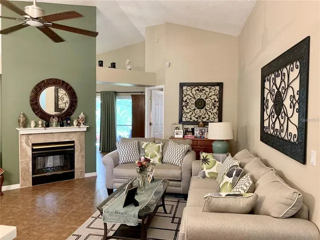 a living room with furniture and a fireplace