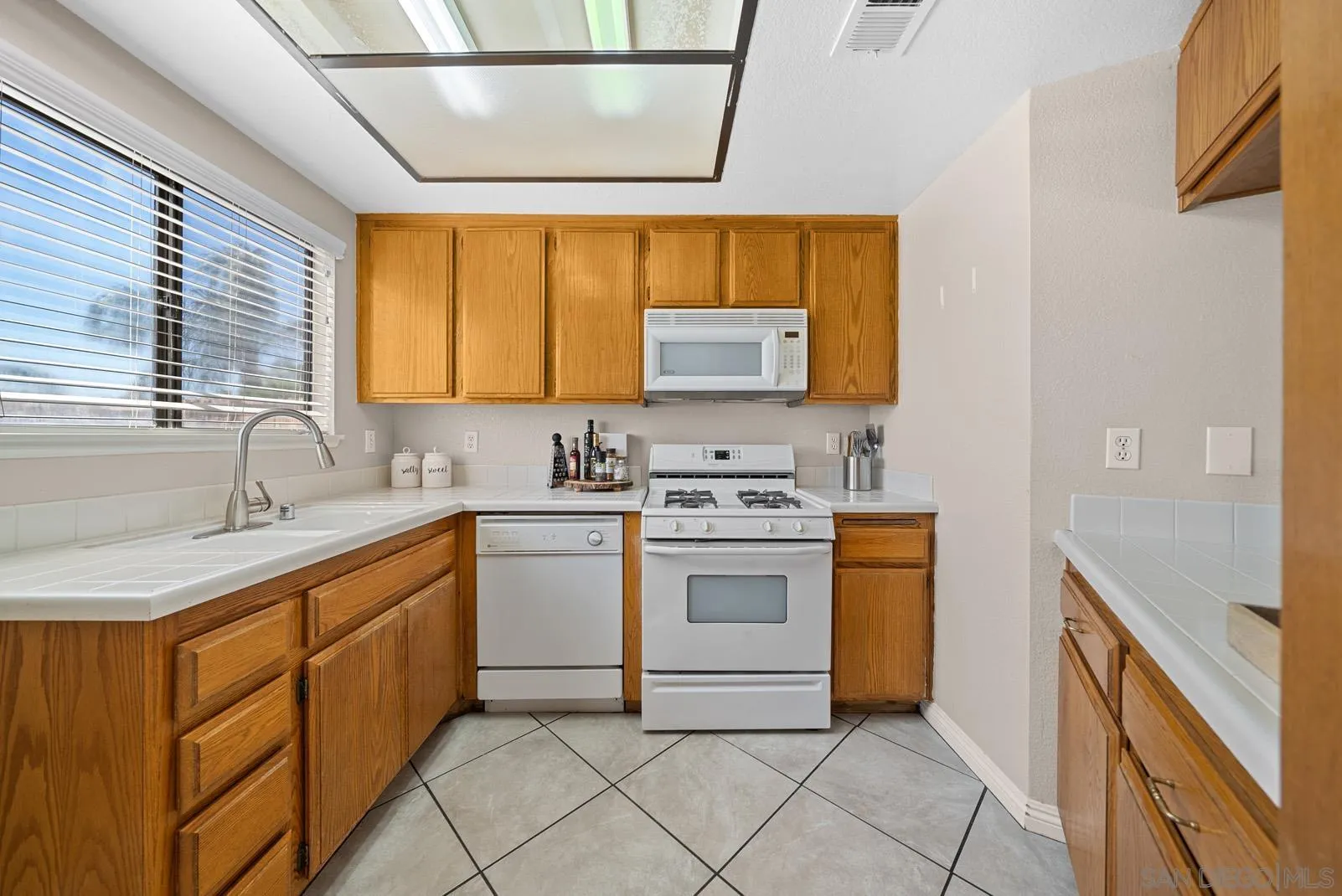 27823 Antelope Road Menifee, CA 92585 - Photo 5 of 49 a kitchen with a sink stove and cabinets