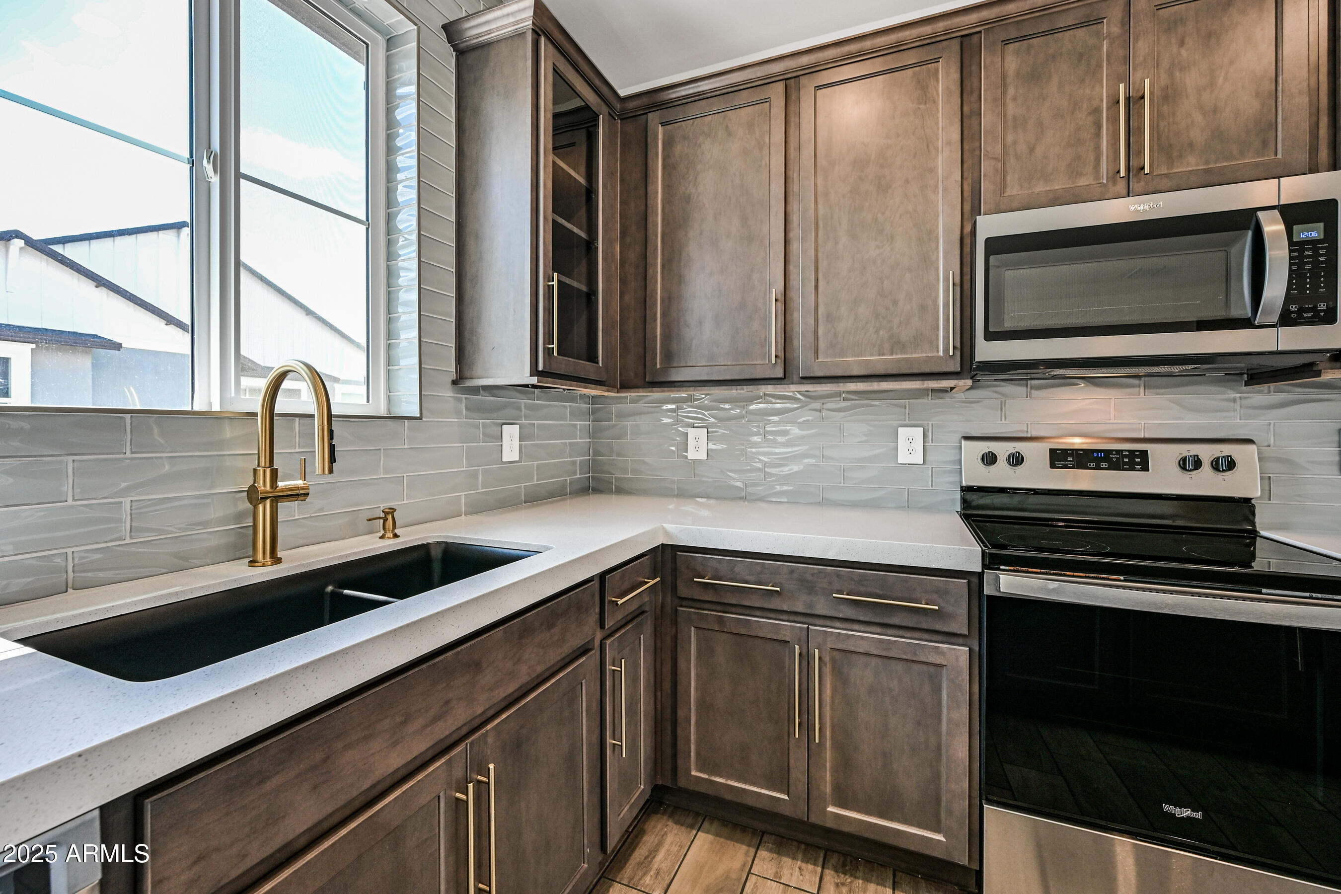 11300 North Casa Dega Drive, Unit 1061 Surprise, AZ 85388 - Photo 15 of 45 a kitchen with stainless steel appliances a stove sink and microwave