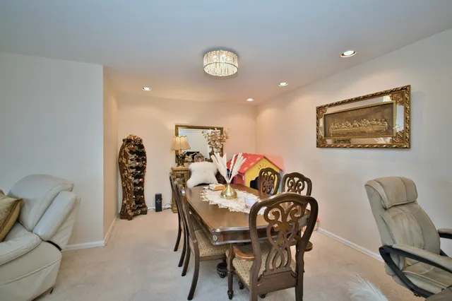 a view of a dining room with furniture and chandelier