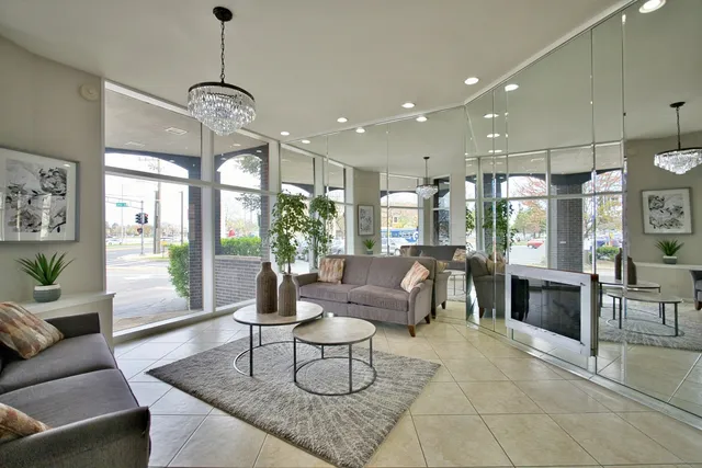 a living room with fireplace furniture and a chandelier