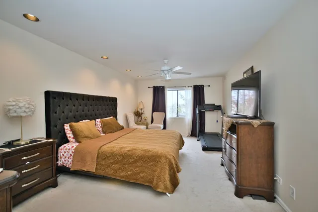 a bedroom with a bed and ceiling fan