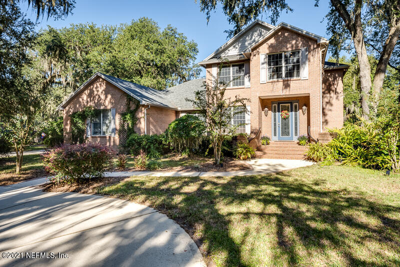 2710 Holly Point Road East Orange Park, FL 32073 - Photo 2 of 64 a white house that has a tree in front of it