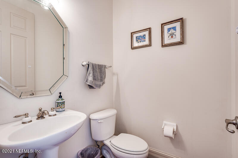 2710 Holly Point Road East Orange Park, FL 32073 - Photo 11 of 64 a bathroom with a sink mirror and toilet