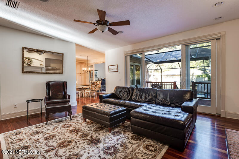 2710 Holly Point Road East Orange Park, FL 32073 - Photo 13 of 64 a living room with furniture and a flat screen tv