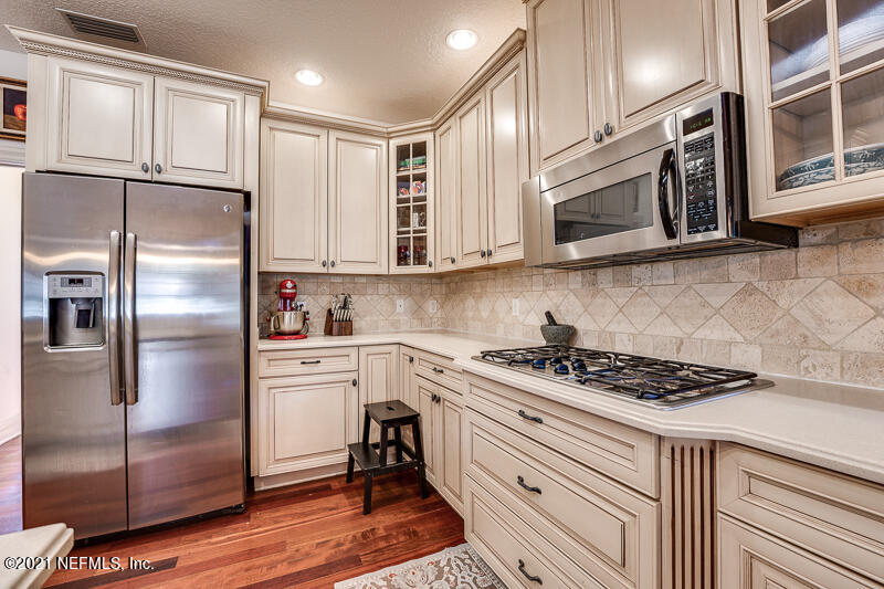 2710 Holly Point Road East Orange Park, FL 32073 - Photo 22 of 64 a kitchen with stainless steel appliances granite countertop a stove a refrigerator and a microwave