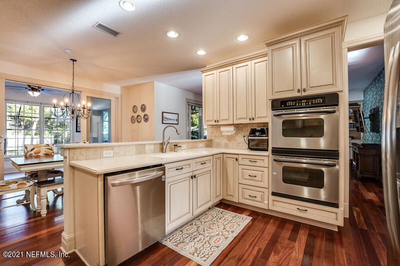 2710 Holly Point Road East Orange Park, FL 32073 - Photo 23 of 64 a kitchen with a sink stove and cabinets