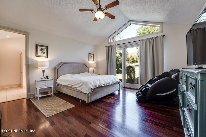 2710 Holly Point Road East Orange Park, FL 32073 - Photo 31 of 64 a bedroom with a bed flat screen tv and window
