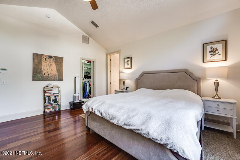 2710 Holly Point Road East Orange Park, FL 32073 - Photo 32 of 64 a bedroom with bed and night stand