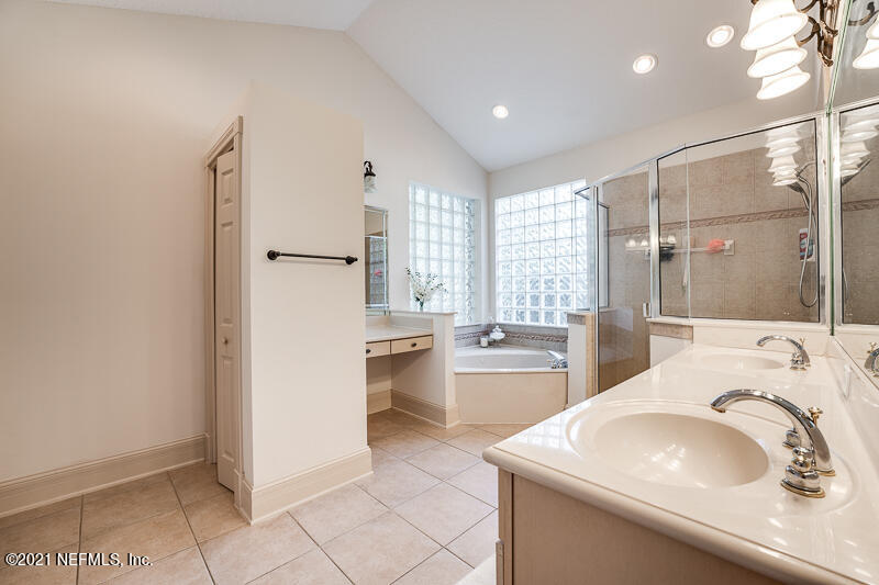 2710 Holly Point Road East Orange Park, FL 32073 - Photo 33 of 64 a bathroom with a sink a toilet and tub
