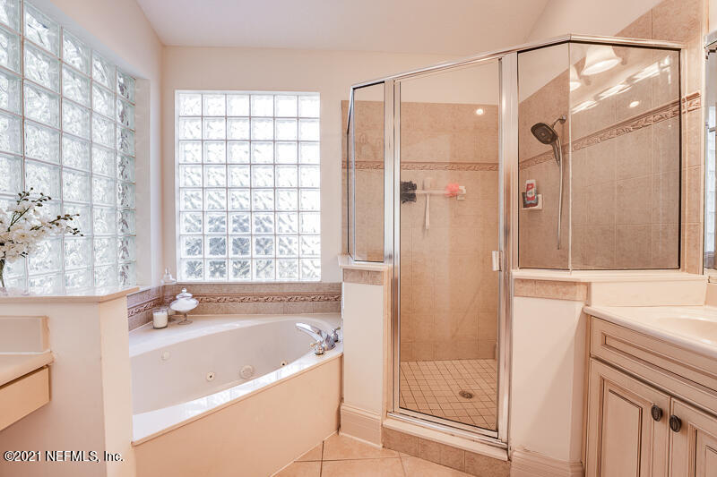 2710 Holly Point Road East Orange Park, FL 32073 - Photo 35 of 64 a bathroom with a bathtub and a shower