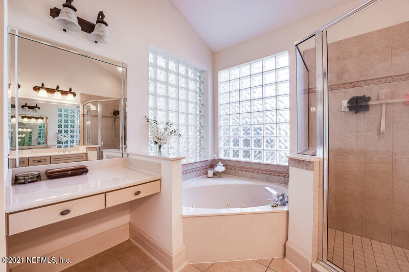 2710 Holly Point Road East Orange Park, FL 32073 - Photo 36 of 64 a bathroom with a tub sink and window