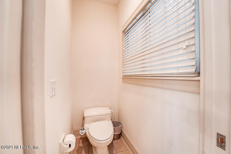 2710 Holly Point Road East Orange Park, FL 32073 - Photo 37 of 64 a white toilet sitting next to a small window