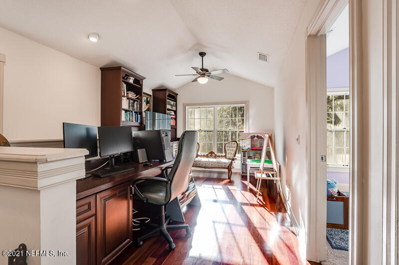 2710 Holly Point Road East Orange Park, FL 32073 - Photo 38 of 64 a view of a workspace with furniture and a window