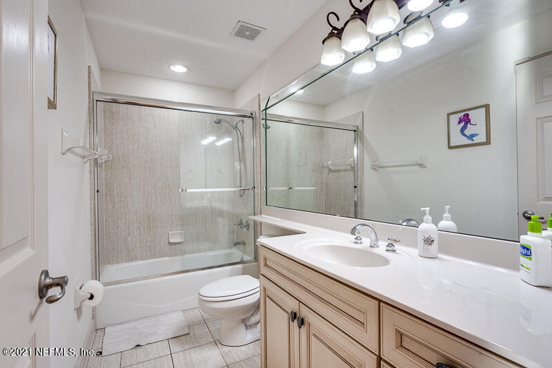 2710 Holly Point Road East Orange Park, FL 32073 - Photo 40 of 64 a bathroom with a sink a toilet and shower
