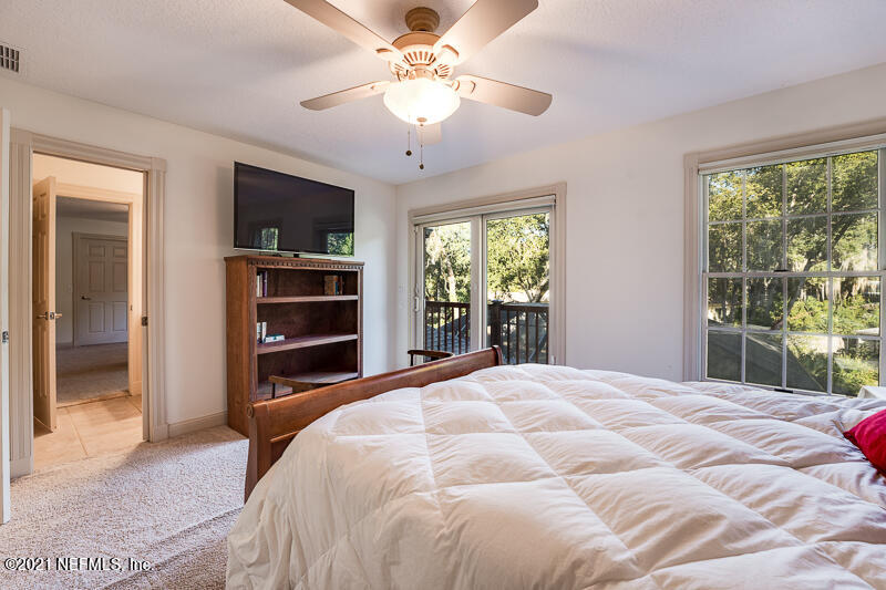 2710 Holly Point Road East Orange Park, FL 32073 - Photo 44 of 64 a bedroom with a bed and a flat screen tv