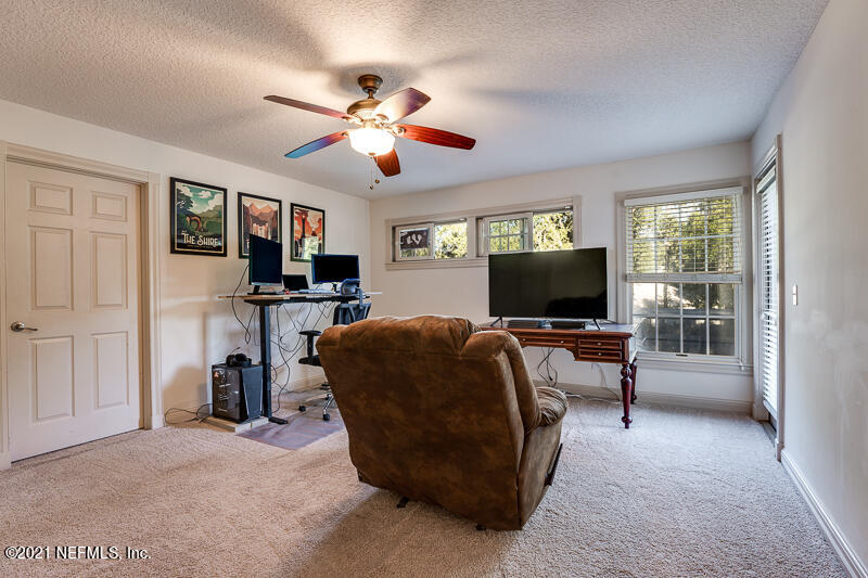 2710 Holly Point Road East Orange Park, FL 32073 - Photo 46 of 64 a living room with furniture and a flat screen tv