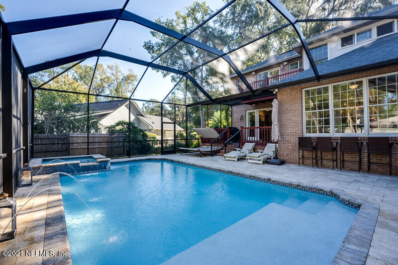 2710 Holly Point Road East Orange Park, FL 32073 - Photo 53 of 64 a view of a swimming pool with a patio and a yard