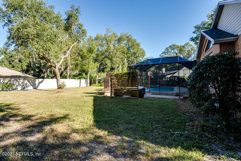 2710 Holly Point Road East Orange Park, FL 32073 - Photo 58 of 64 a view of yard with swimming pool and green space