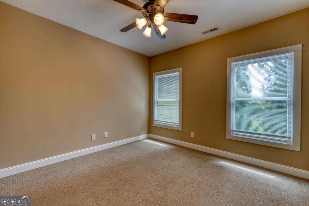 1401 Lakeside Road, Unit 502 Hiawassee, GA 30546 - Photo 29 of 46 a view of an empty room with window and chandelier fan